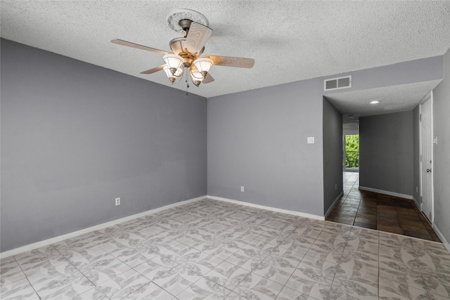 spare room featuring a textured ceiling and ceiling fan