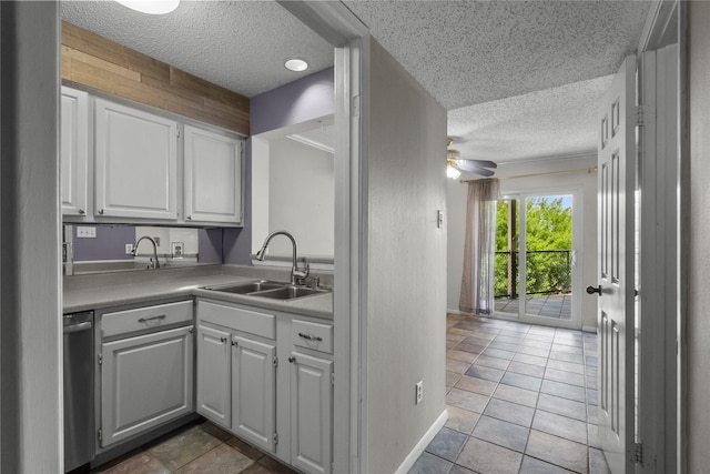 kitchen with sink, light tile patterned floors, ceiling fan, white cabinets, and stainless steel dishwasher