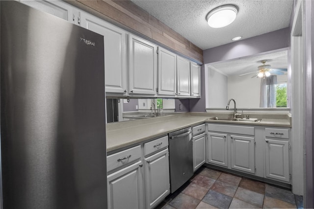 kitchen with white cabinetry, appliances with stainless steel finishes, sink, and a textured ceiling