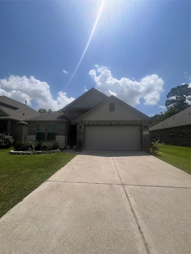 single story home featuring a garage and a front yard