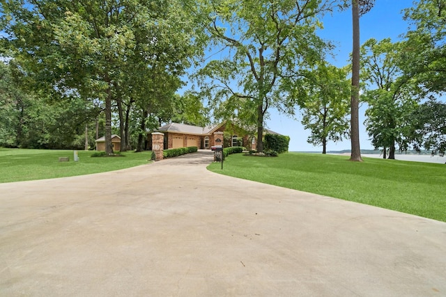 ranch-style house with a front yard and a garage