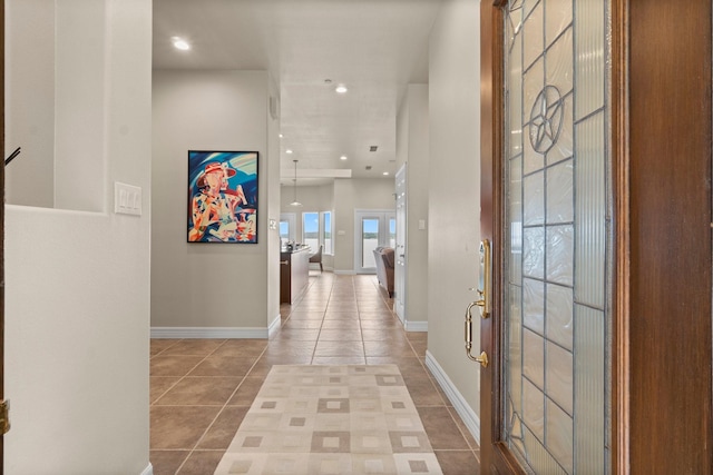 hallway with tile patterned flooring