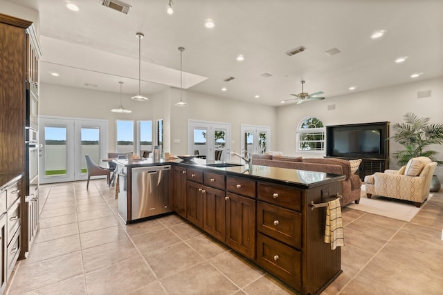 kitchen with ceiling fan, sink, stainless steel appliances, and french doors