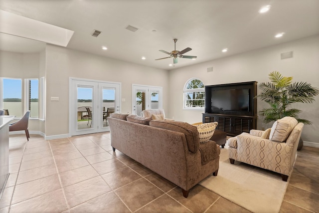 living room featuring ceiling fan, light tile patterned floors, and french doors