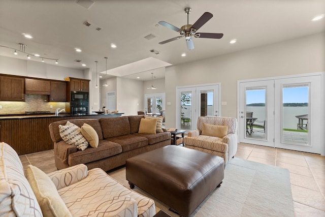 living room with ceiling fan, sink, french doors, and light tile patterned flooring