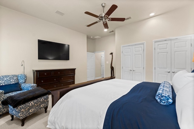 bedroom featuring ceiling fan and multiple closets