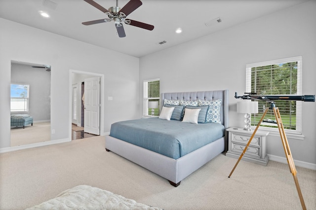 carpeted bedroom featuring ceiling fan and multiple windows