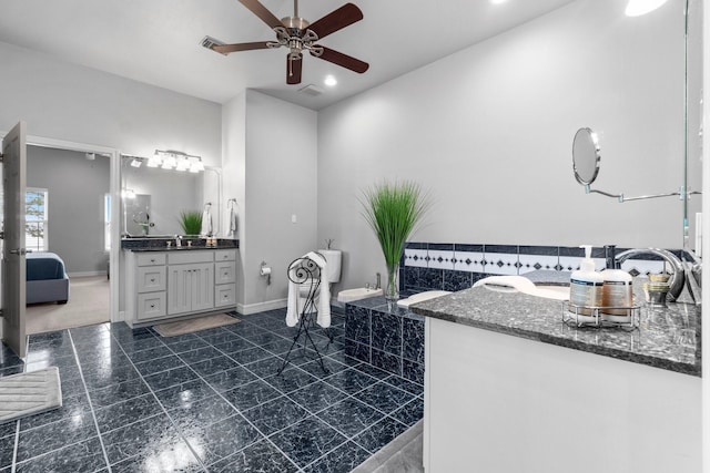 bathroom with ceiling fan and vanity