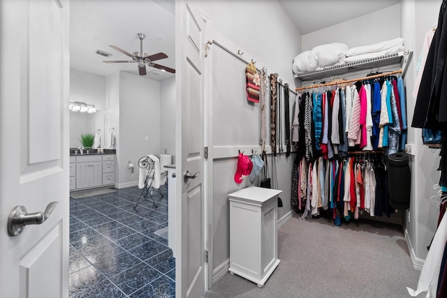 spacious closet with ceiling fan