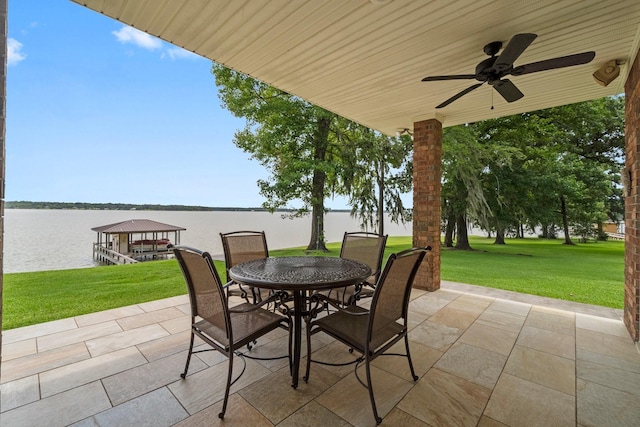 view of patio / terrace with ceiling fan and a water view