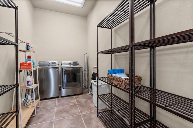 laundry area featuring tile patterned flooring and washing machine and clothes dryer