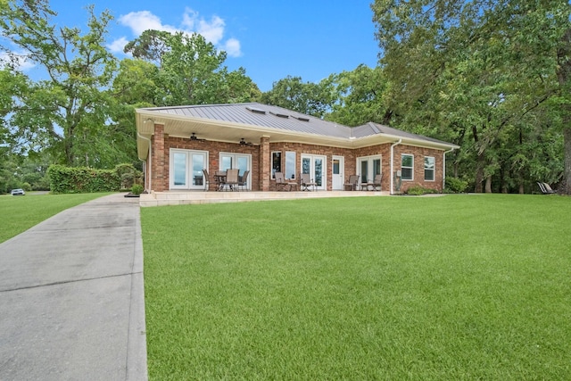 rear view of property featuring a yard and french doors