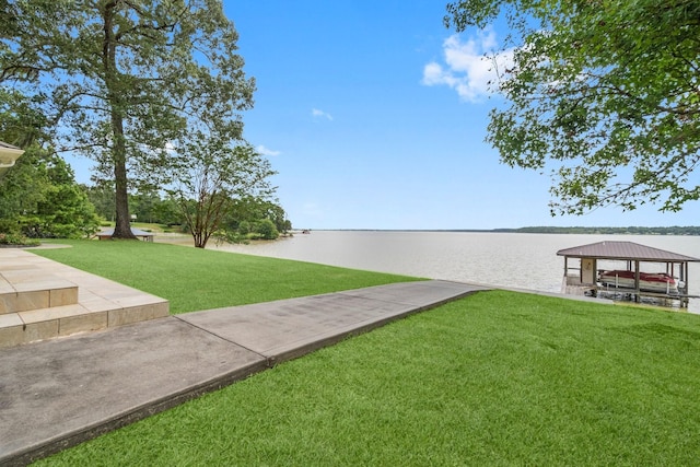 dock area featuring a water view, a gazebo, and a yard