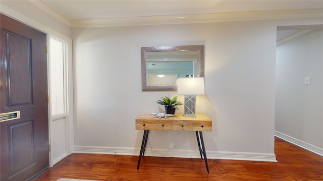 entrance foyer with ornamental molding and hardwood / wood-style flooring