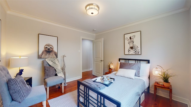 bedroom with ornamental molding and wood-type flooring