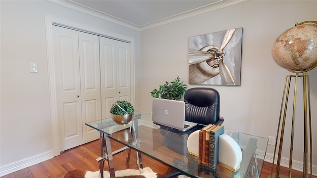 home office with ornamental molding and wood-type flooring