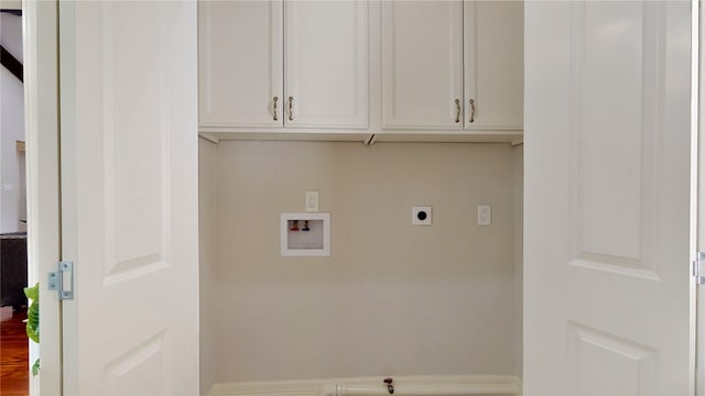 clothes washing area featuring electric dryer hookup, cabinets, and washer hookup