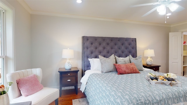 bedroom featuring dark hardwood / wood-style flooring, crown molding, and ceiling fan