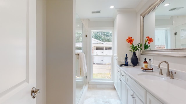 bathroom with ornamental molding, vanity, tile patterned flooring, and plenty of natural light