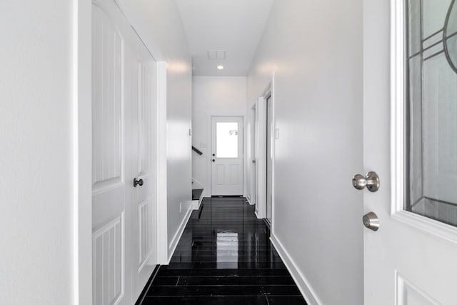 corridor with dark hardwood / wood-style flooring