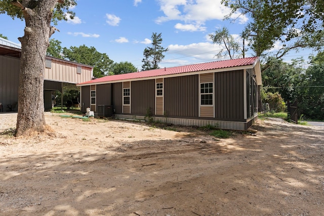 view of front of home with metal roof and central AC unit