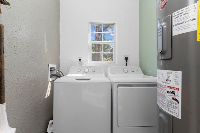 laundry area featuring water heater and washer and dryer