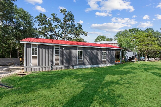 rear view of house with a yard