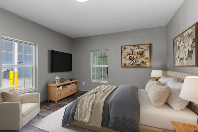 bedroom featuring dark wood-style floors and baseboards