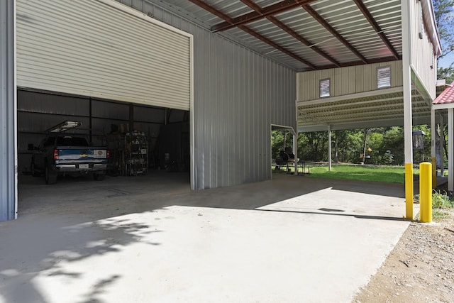 garage with a carport and driveway