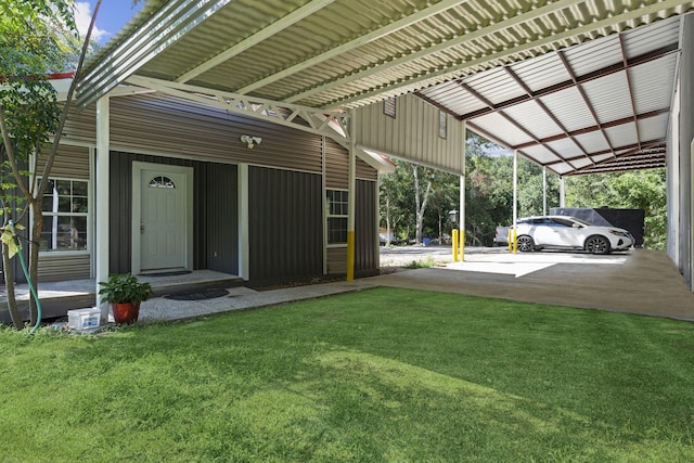 view of vehicle parking with entry steps, driveway, and an attached carport