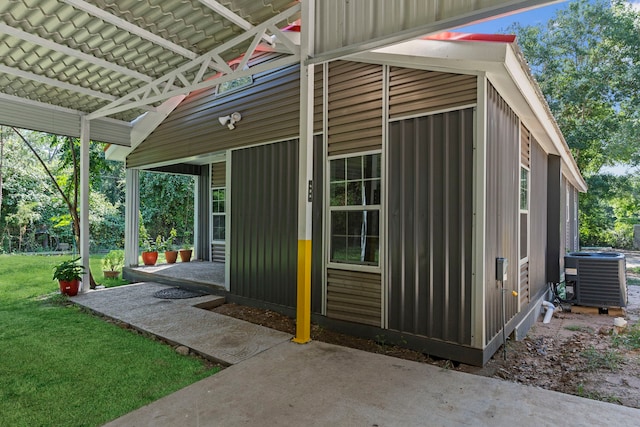 view of outbuilding featuring central AC unit and a yard