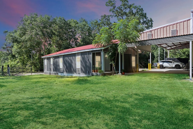 yard at dusk featuring a carport