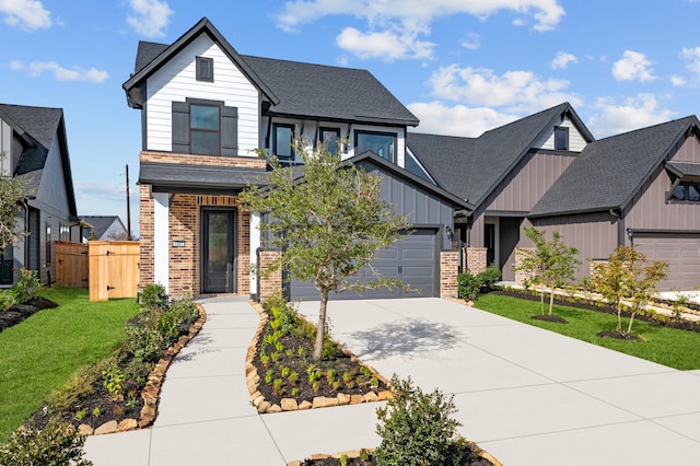 view of front of property featuring a front lawn and a garage