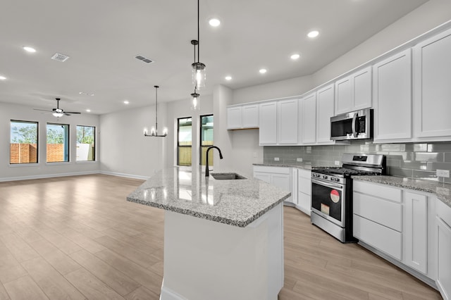 kitchen featuring white cabinetry, sink, and appliances with stainless steel finishes