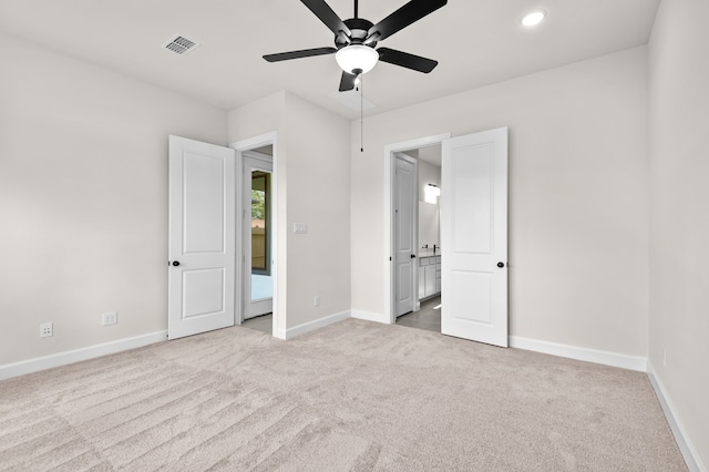 unfurnished bedroom featuring light colored carpet and ceiling fan