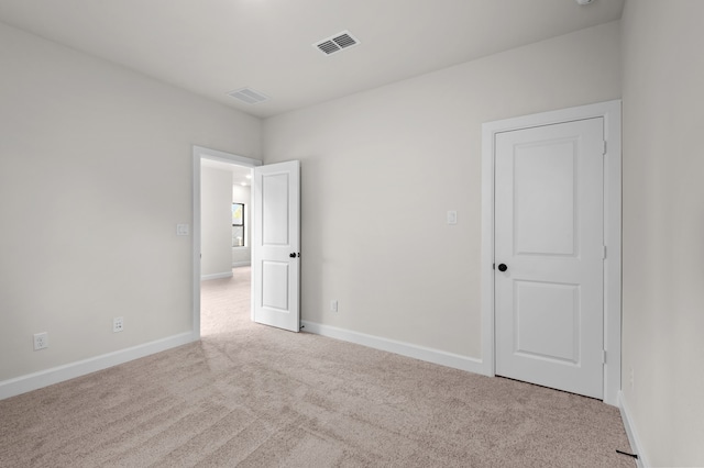 spare room with light colored carpet