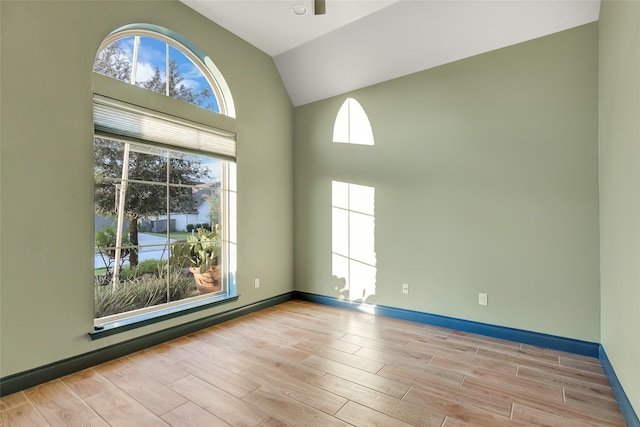 unfurnished room with high vaulted ceiling and light hardwood / wood-style flooring