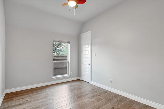 empty room featuring light hardwood / wood-style floors, ceiling fan, and lofted ceiling