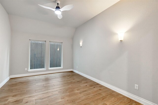 empty room with light hardwood / wood-style flooring, vaulted ceiling, and ceiling fan