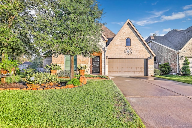 view of front of property featuring a garage and a front lawn