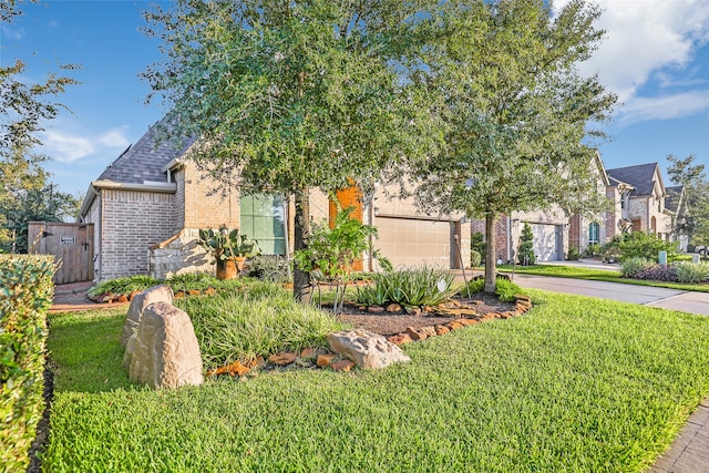 obstructed view of property with a front yard and a garage