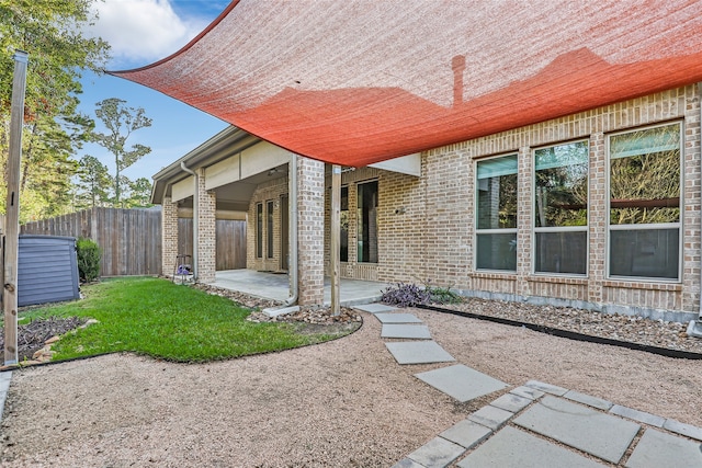 exterior space featuring a lawn and a patio