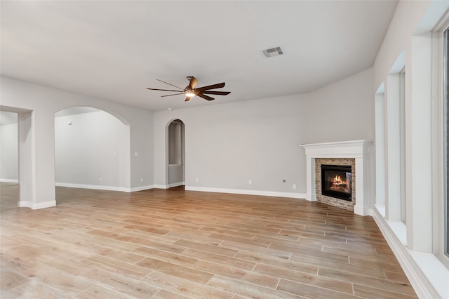 unfurnished living room featuring ceiling fan and light hardwood / wood-style floors