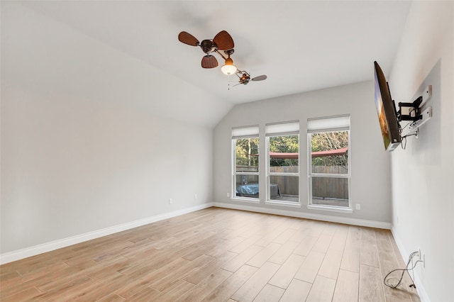 spare room with ceiling fan, light hardwood / wood-style floors, and lofted ceiling