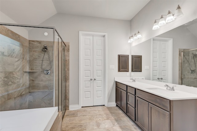 bathroom featuring vanity, vaulted ceiling, and an enclosed shower