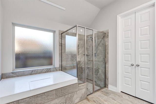 bathroom with lofted ceiling and shower with separate bathtub