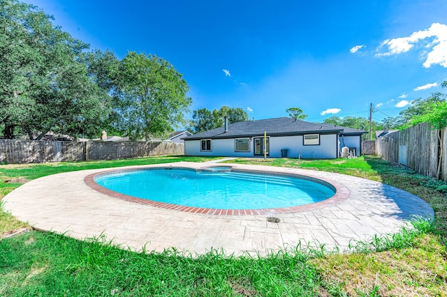 view of pool with a patio area and a lawn