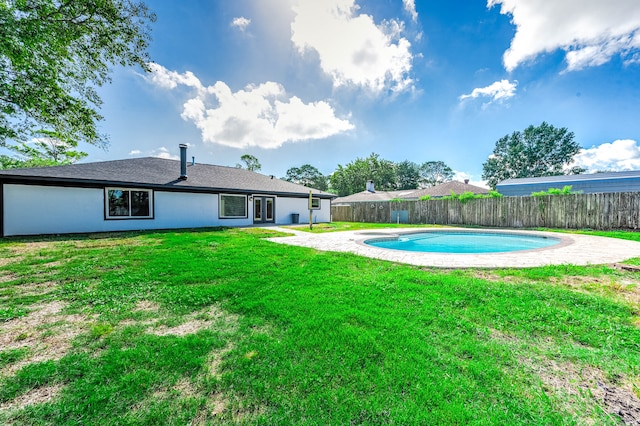 view of pool with a yard