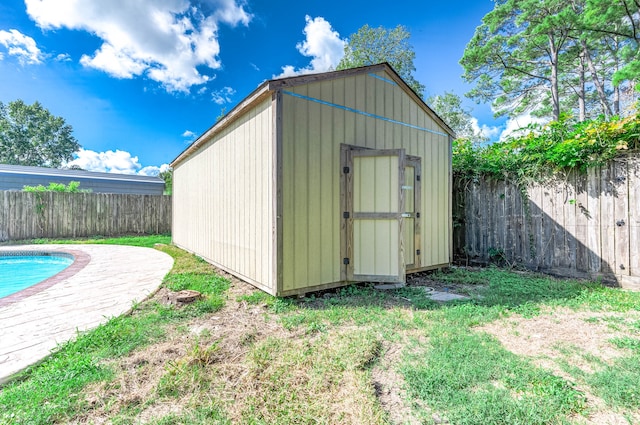 view of outbuilding with a fenced in pool