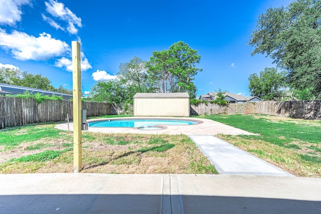 view of pool with a shed and a yard